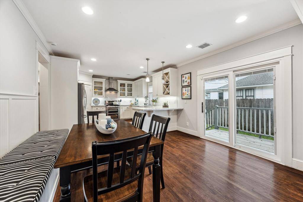 Large sliding glass doors allow natural light to flood the space and provide access to the side yard.
