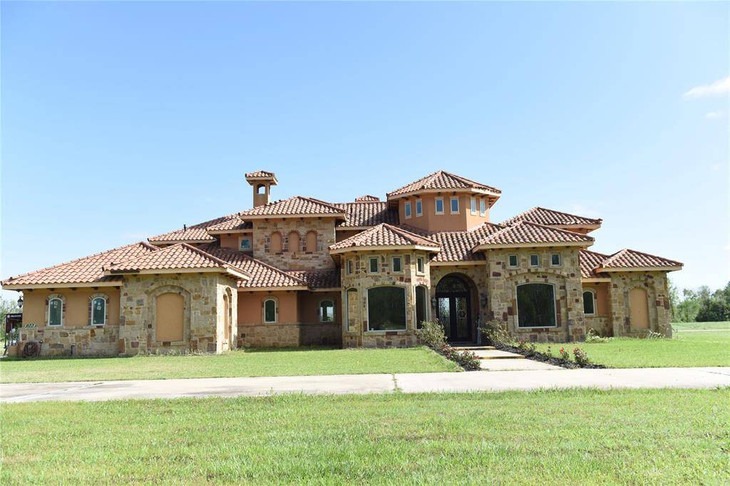 Mediterranean Dream Home, with Italian clay tile roof, stone and stucco.