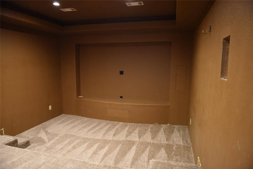 Antique white finish vanity with granite countertop, and travertine tile floors.