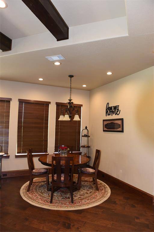 Covered patio with stone fireplace for entertaining.