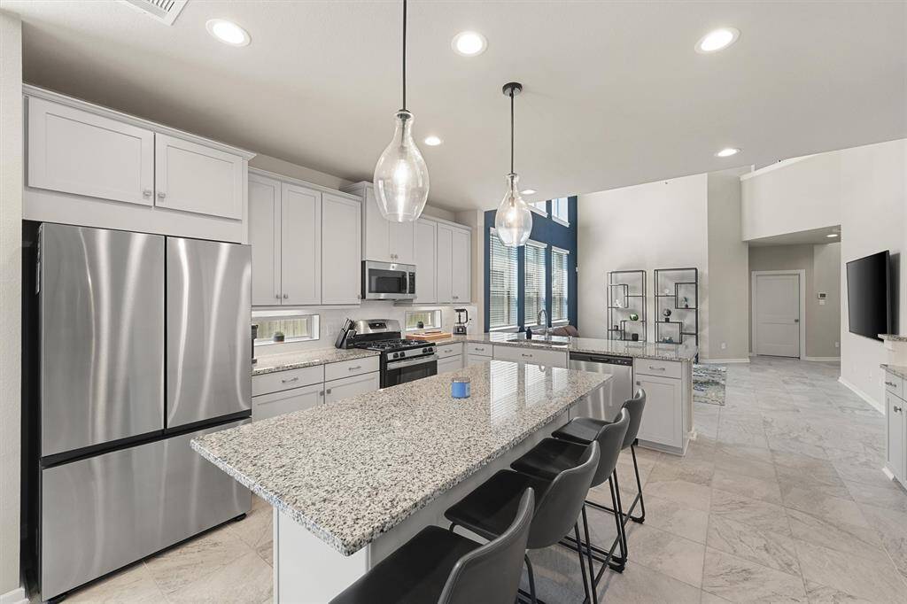 More natural light in the kitchen with these pretty soffit windows. Enjoy cooking on the gas range.