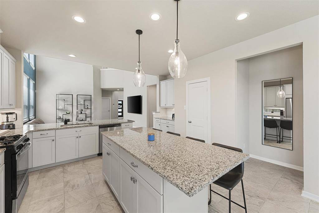 Beautiful glass pendants hang above a large island.