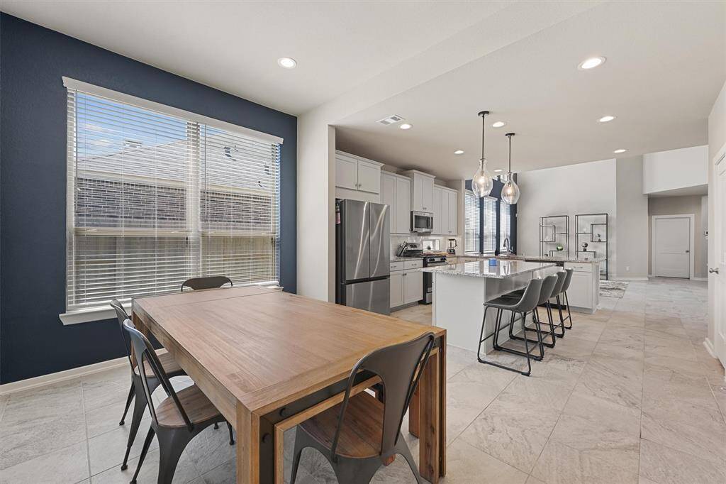 Open concept living is great for hosting big crowds. The breakfast room is spacious. There's room to seat 8 a this table!