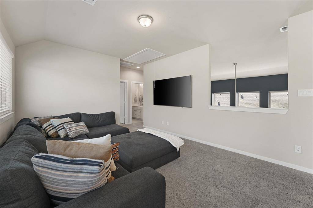 The upstairs gameroom offers a versatile area for entertainment, games, or a cozy movie night.