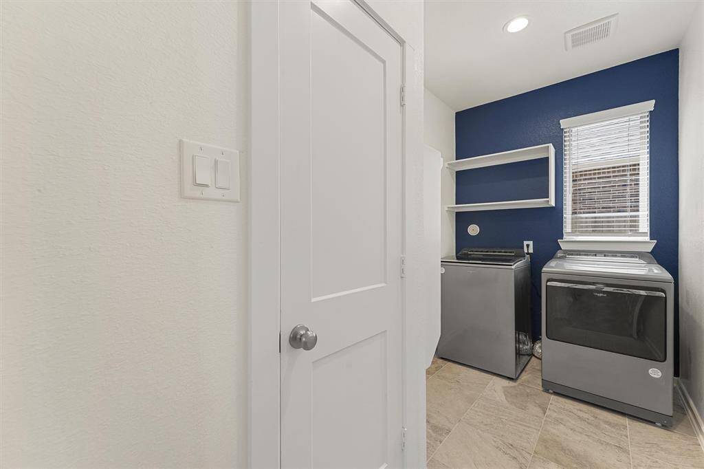 The laundry room has a coat closet and ample storage space. It's locted near the garage.