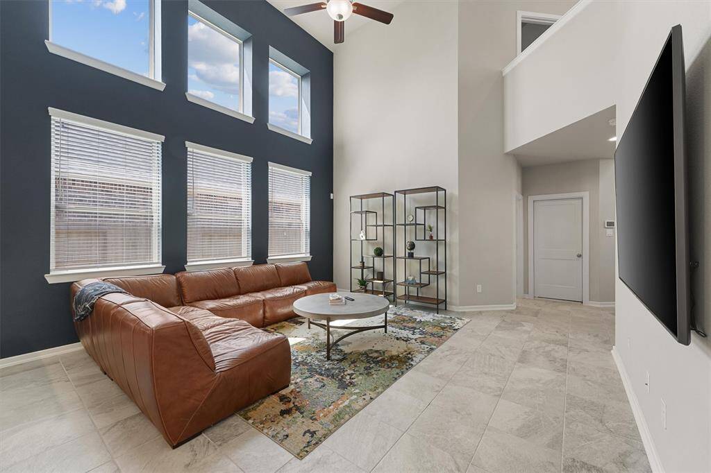 Navy accent wall in the Living Room draws your eye to the gorgeous wall of windows letting in natural light.
