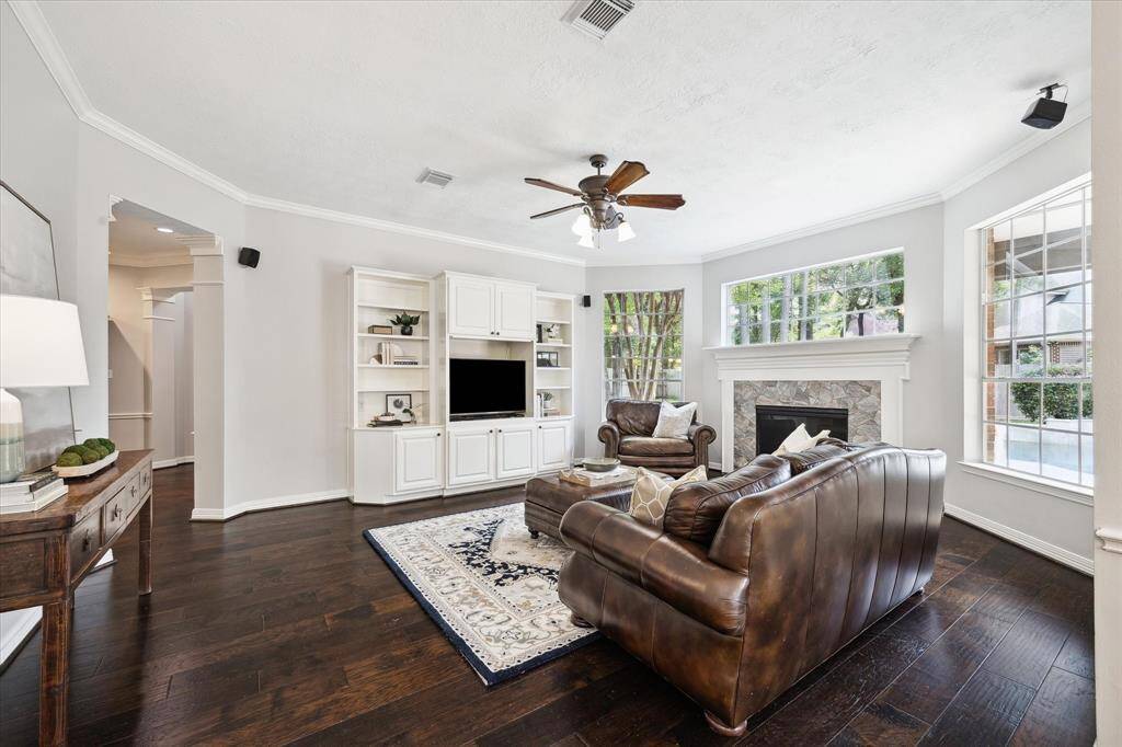 The living room overlooks the backyard oasis and with one of the two gas fireplaces in this home
