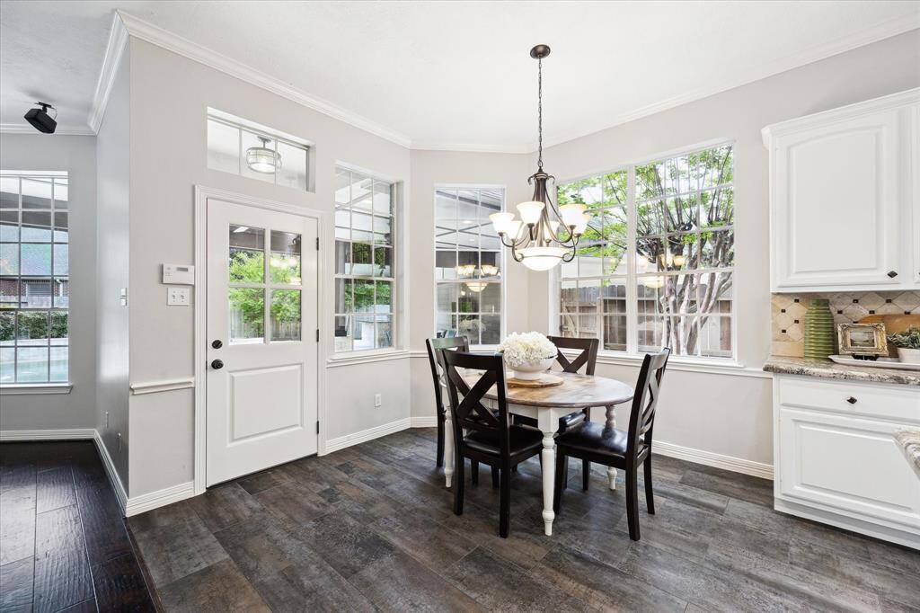 Breakfast room just off the kitchen with many windows and access to the covered back patio.