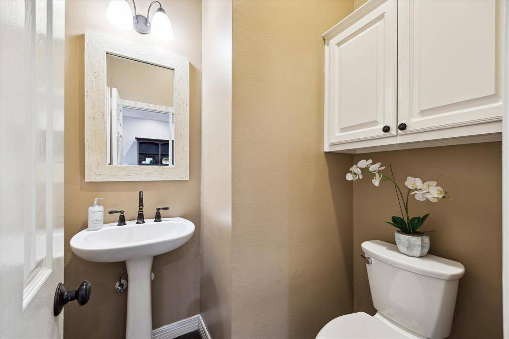 Powder room is located downstairs, just off the foyer.