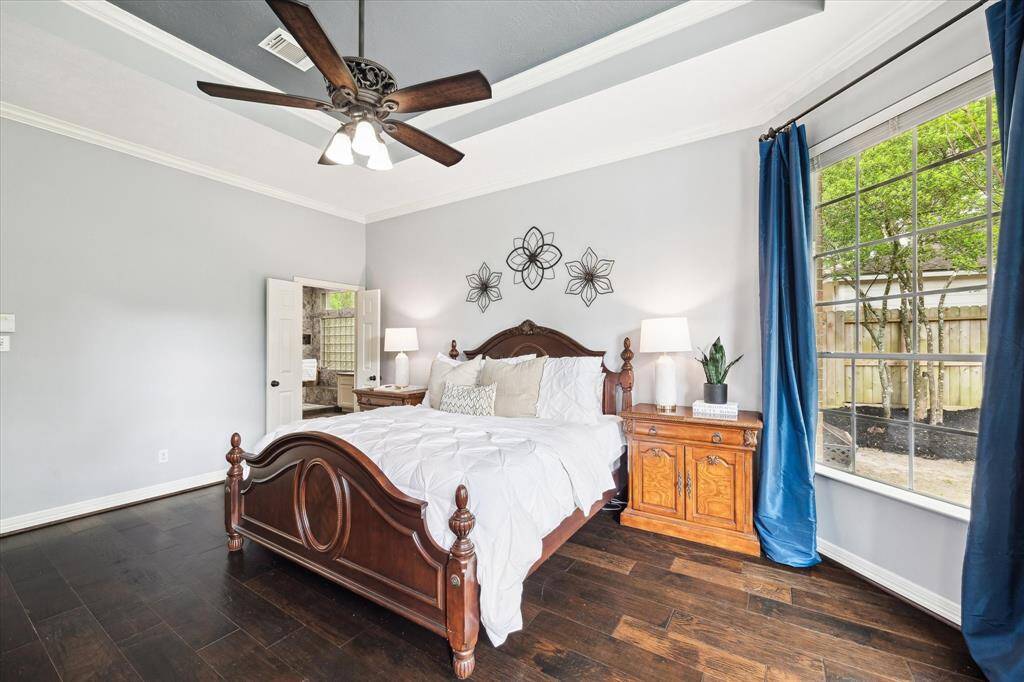 Large windows overlooking the backyard in the primary bedroom offer an abundance of natural light.