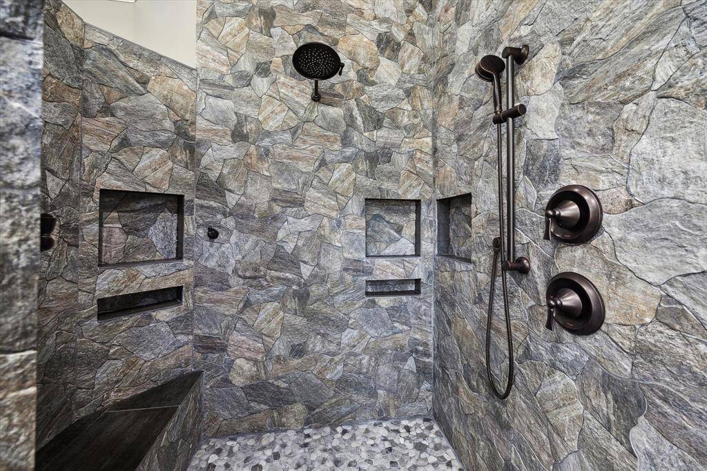 The remodeled primary bath has a large walk-in shower and shower seating area.