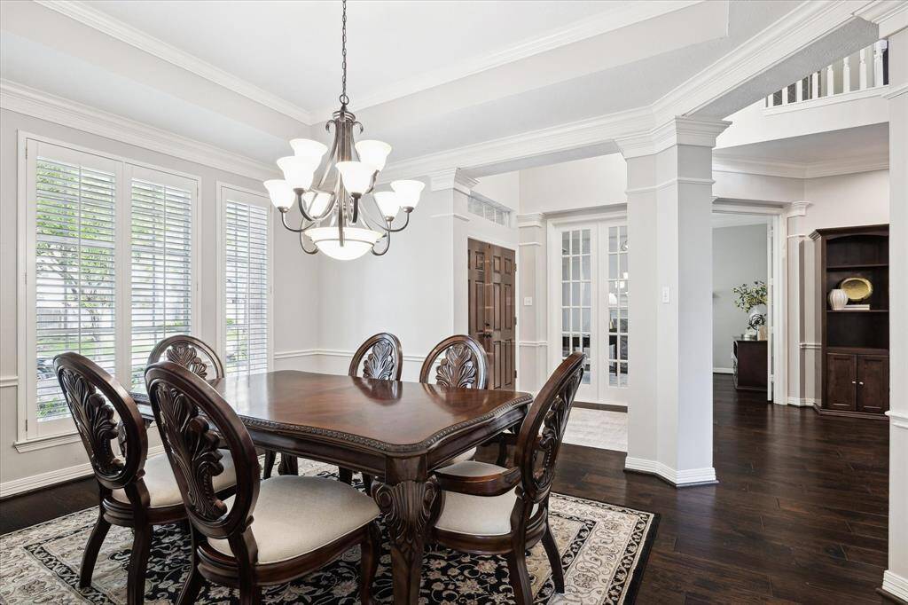 Facing from the kitchen pass-through back towards the foyer. Large picturesque windows across the front allow for ample natural light to fill the dining room.