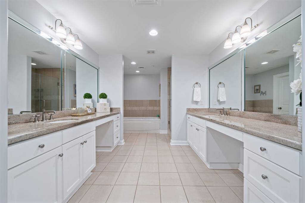 Step into the attached en-suite bathroom and discover a spa-like atmosphere, complete with abundant built-in storage closets that ensure a place for everything—from linens to luxe essentials.