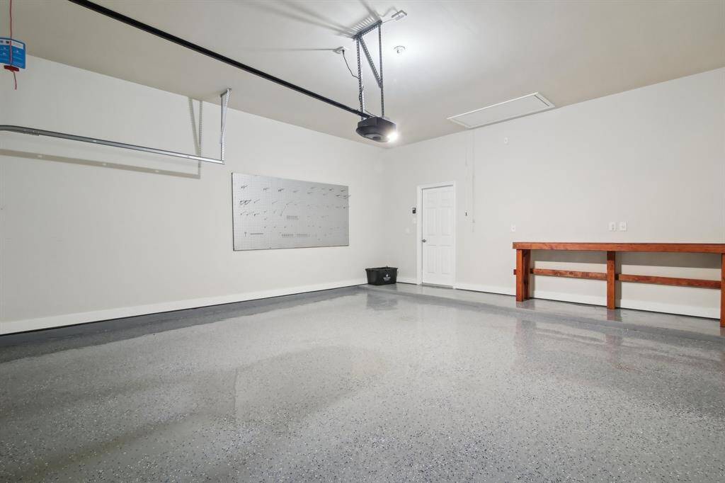 Attached 2 Car Garage featuring epoxy flooring and new motor