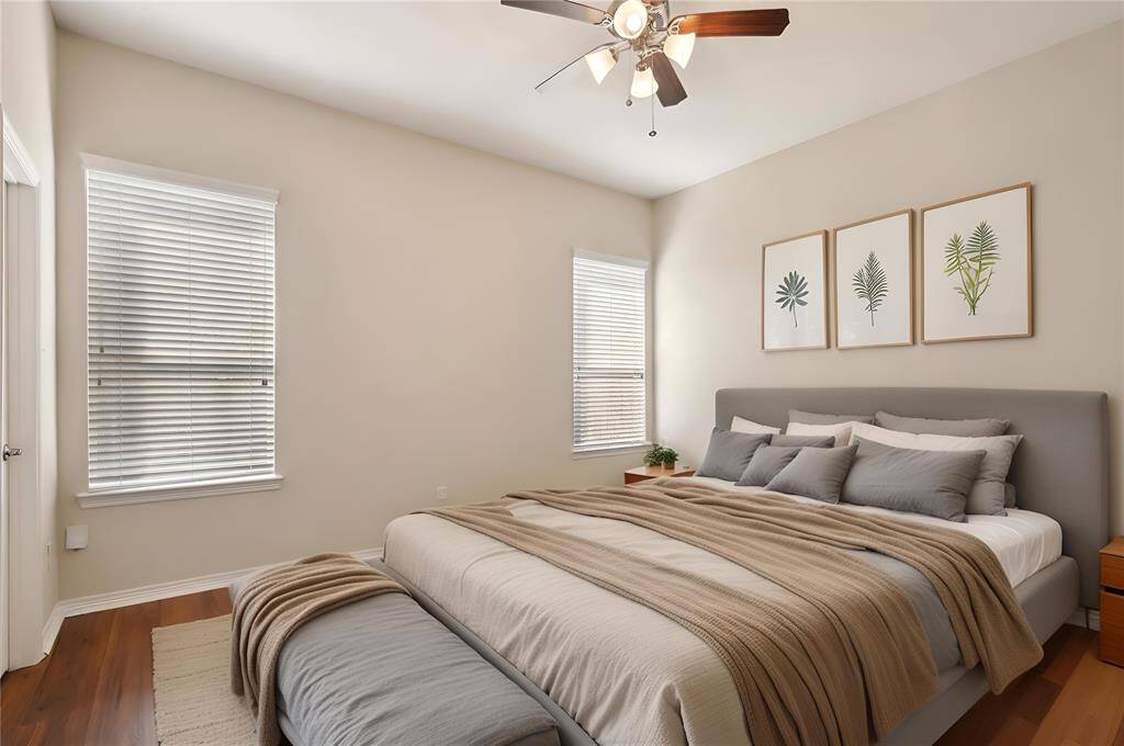Bright and airy primary bedroom. This photo has been virtually staged.