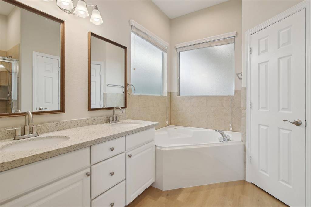 Primary bath featuring upgraded double sink vanity and spacious tub