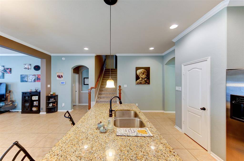 Across from the kitchen is the stairway to the spacious game room & 1/2 bath