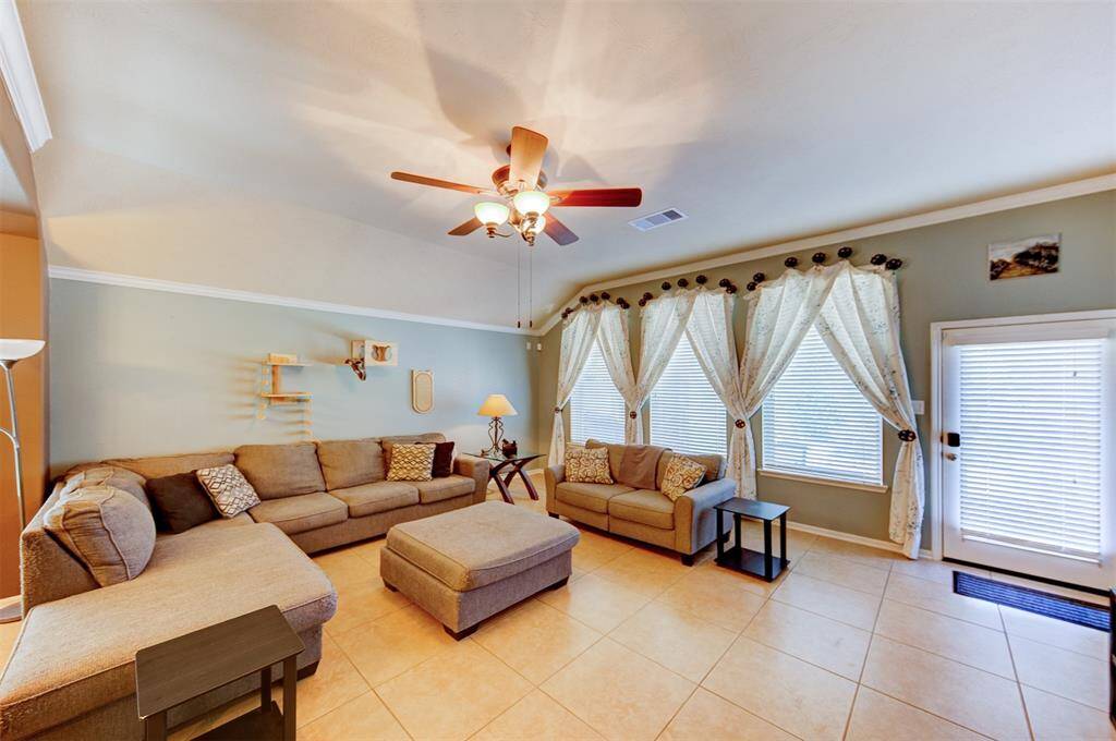 Huge family room with a wall of windows for natural light