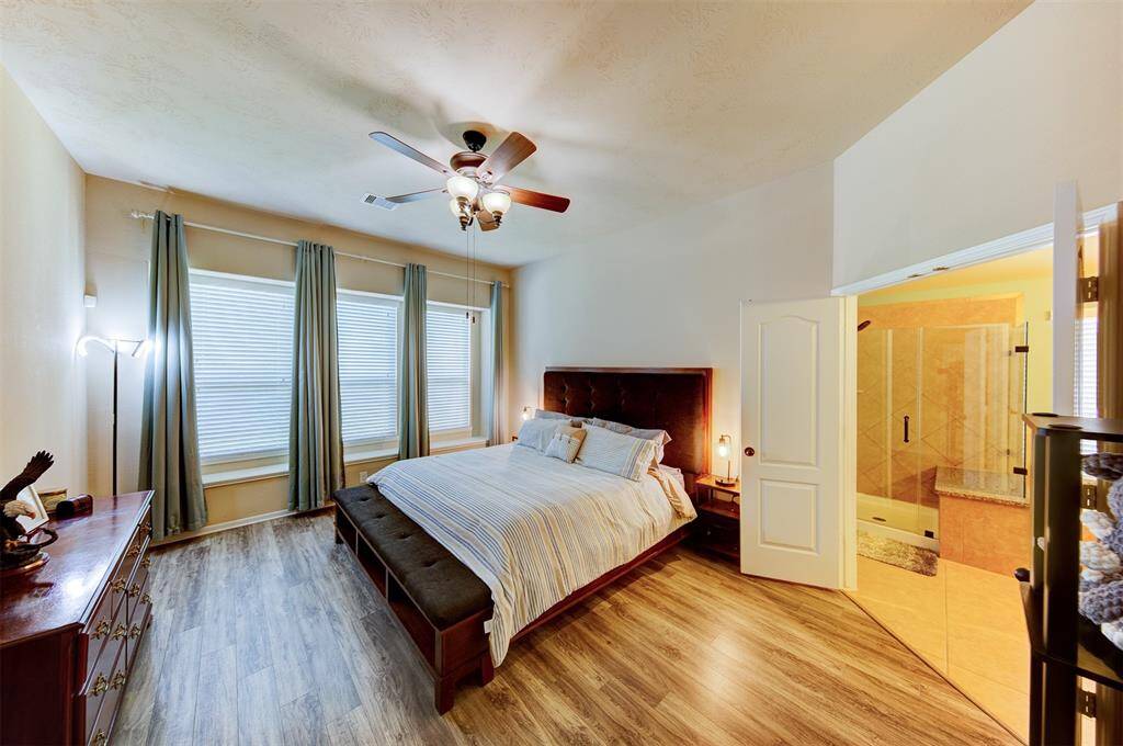 The owner's suite is located at the back of the home for added privacy - notice the wall of windows with window seats