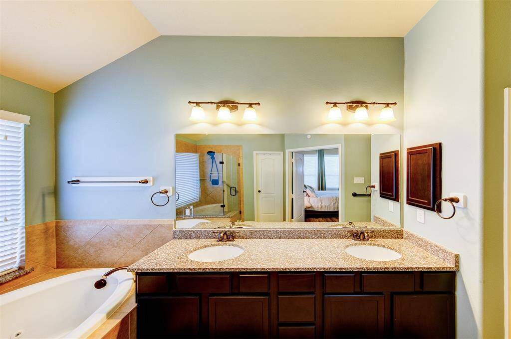 Double lavatories, granite counter with undermount sinks, oiled bronze hardware throughout - separate water closet & linen closet to the right