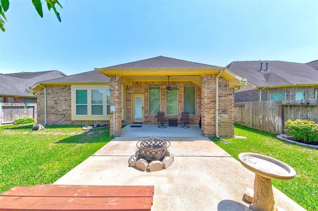 Great view of the back of the home - all 4 sides brick - the extended patio has wiring for a hot tub