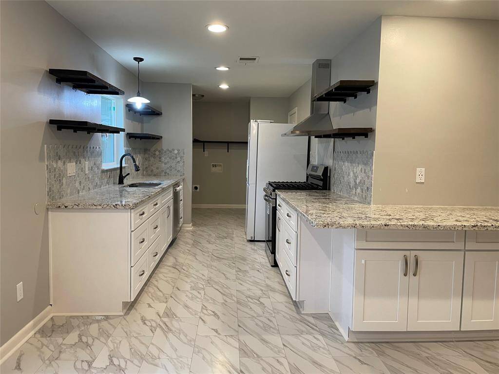 Completely remodeled kitchen with granite counter tops, beautiful floating shelves and new appliances that are less than 3 years old. Refrigerator included!
