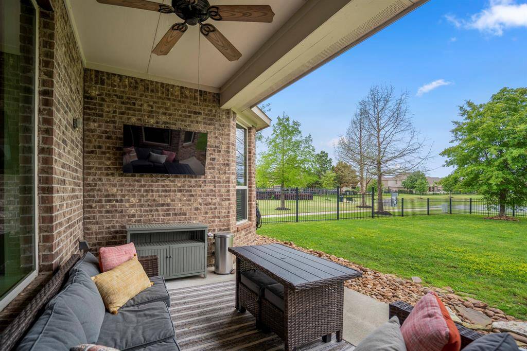 Enjoy outdoor living at its finest with this covered patio featuring panoramic views of the lake.
