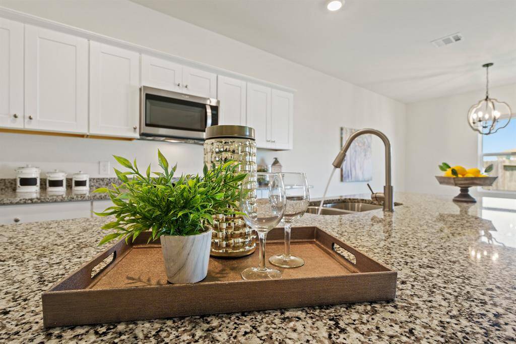The Kitchen Island is large in size and provides an abundance of open space for prep work, decorating cookies, or showcasing a holiday spread. An undermount, stainless steel, dual basin sink with pull down spray nozzle makes cleanup a breeze.