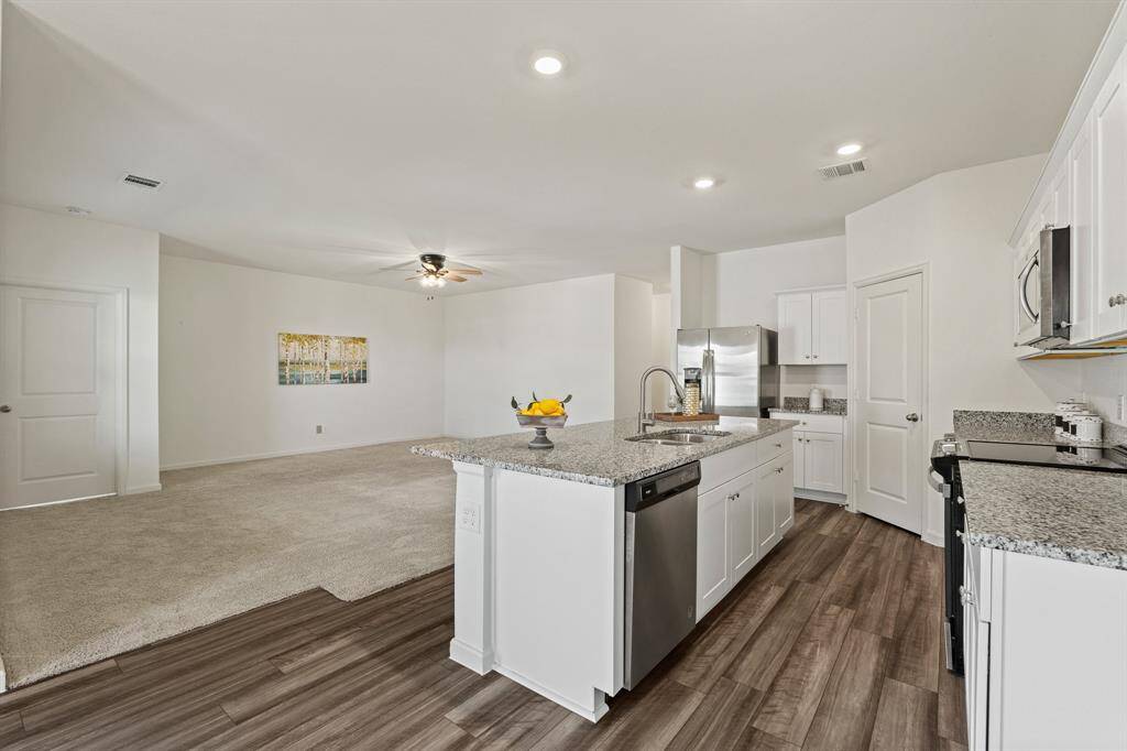 This step back shows how the Kitchen has open sightlines into the Living Room making it easy to entertain.