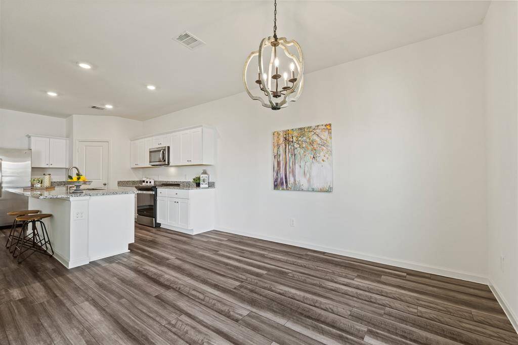 A country modern styled chandelier adds rustic charm while illuminating the room. The Breakfast Room can easily accommodate a 6-person table in addition to a buffet or drink cart.