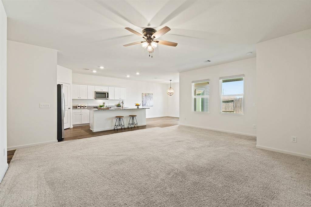 This angle shows how spacious the Living Room is, as well as its close proximity to the Kitchen. This desirable open concept design allows conversation to flow freely when entertaining crowds both big and small.