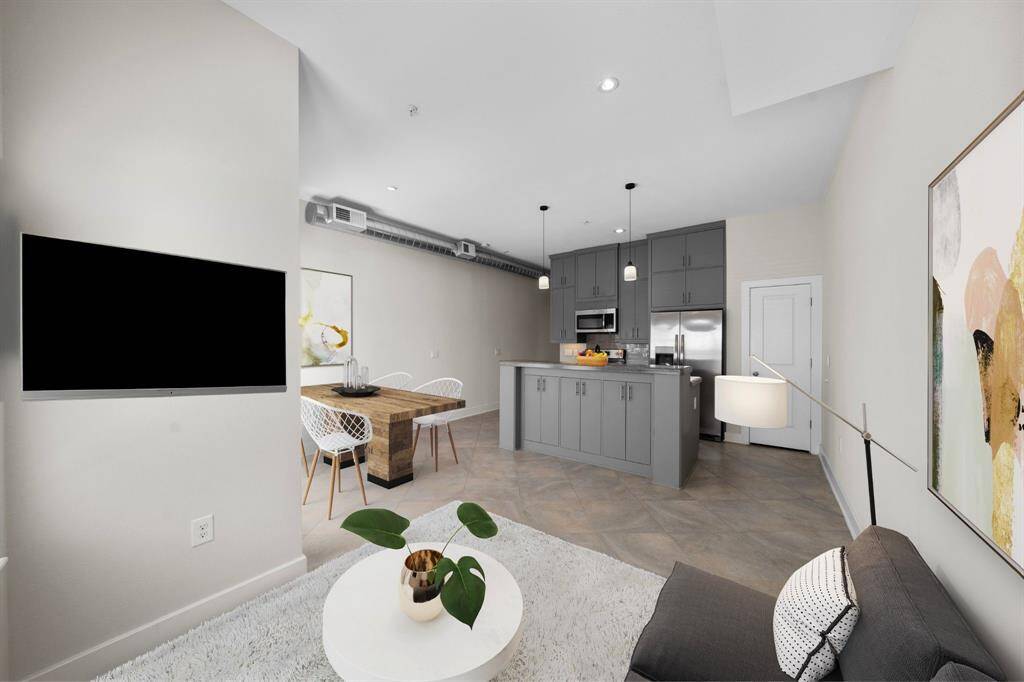 Stylish and spacious! This open-concept living area seamlessly connects to the dining and kitchen, creating the perfect space for entertaining and everyday comfort. (Digitally staged)