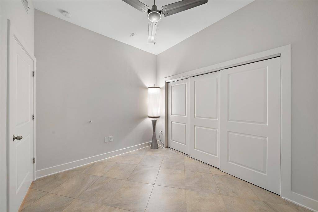 Another perspective of this stylish bedroom, highlighting its bright and modern comfort.