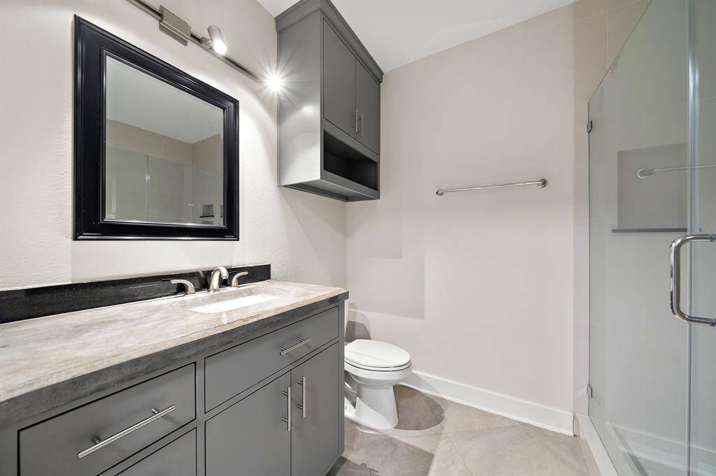 Sleek bathroom featuring a spacious walk-in shower for a spa-like experience.