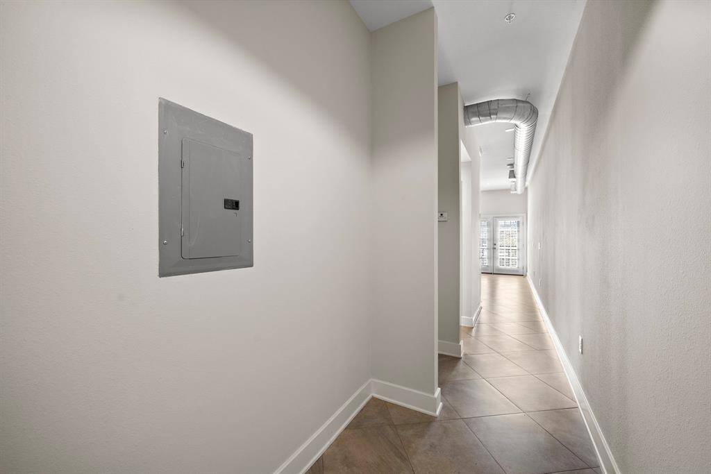 This inviting hallway sets the tone, with space on the left for an entry table, mirror, or artwork—perfect for a grand first impression.