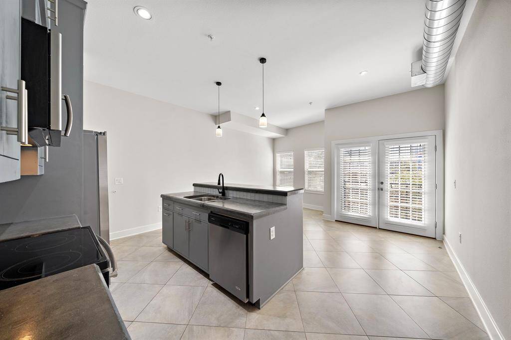 Seamless flow from kitchen to dining and living areas, beautifully separated by a stylish island—perfect for effortless entertaining!