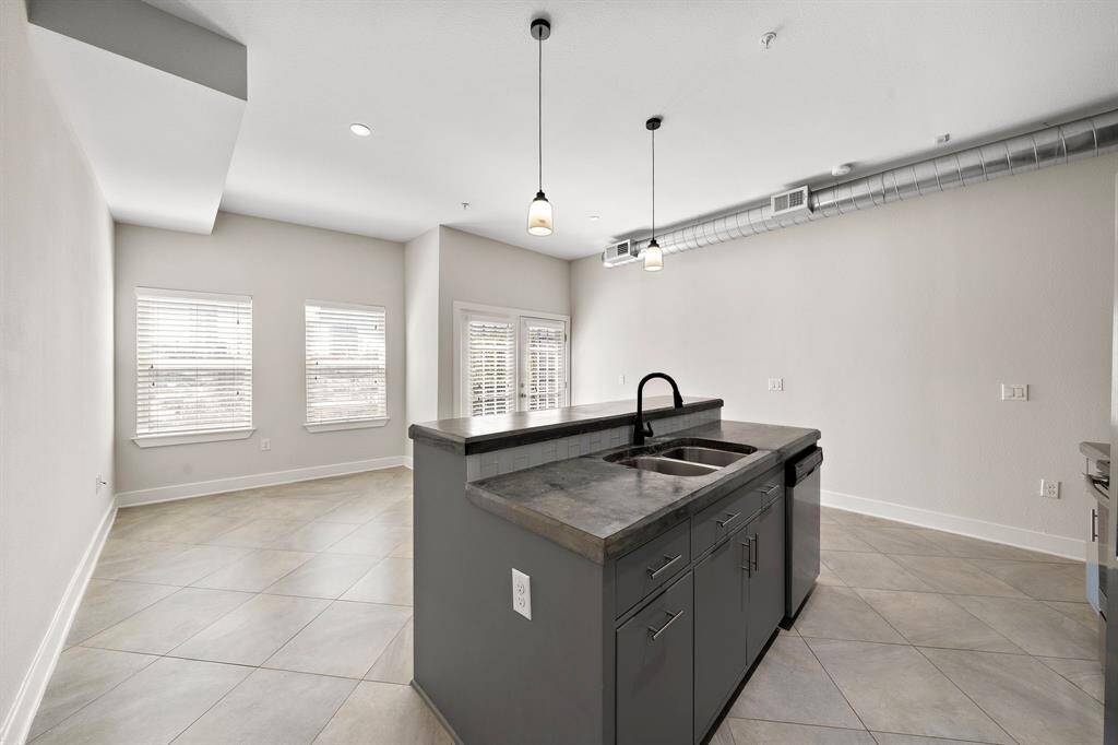 Another perspective showcasing the open flow from the kitchen to the dining and living areas, with the island serving as the perfect centerpiece for gatherings.