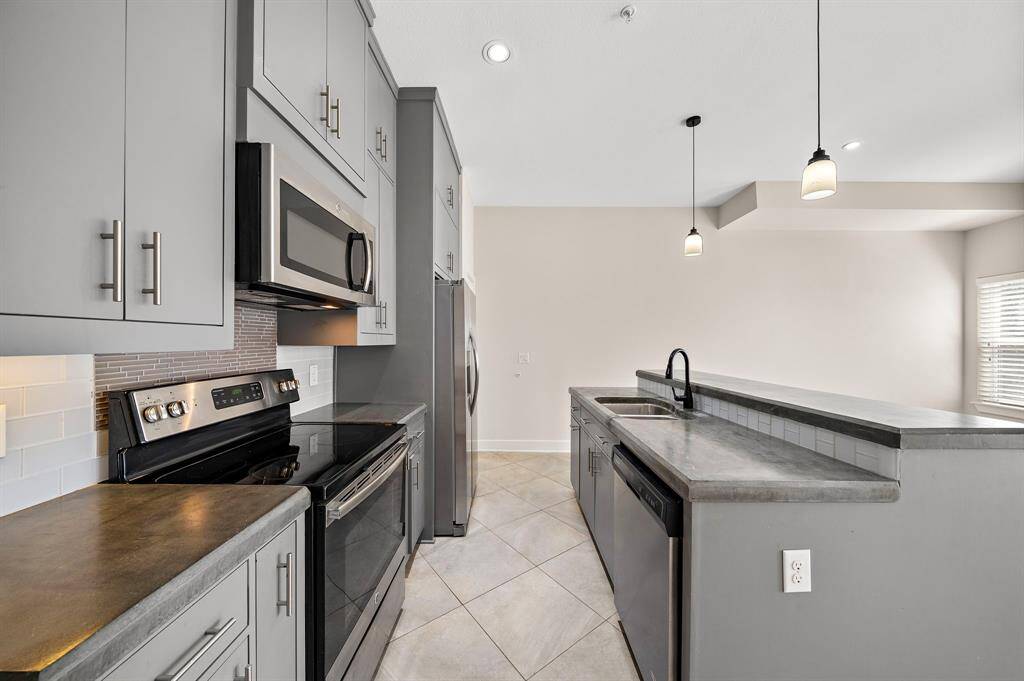 Elegant extended-height kitchen cabinets reach the ceiling, offering ample storage and a sleek, sophisticated look.