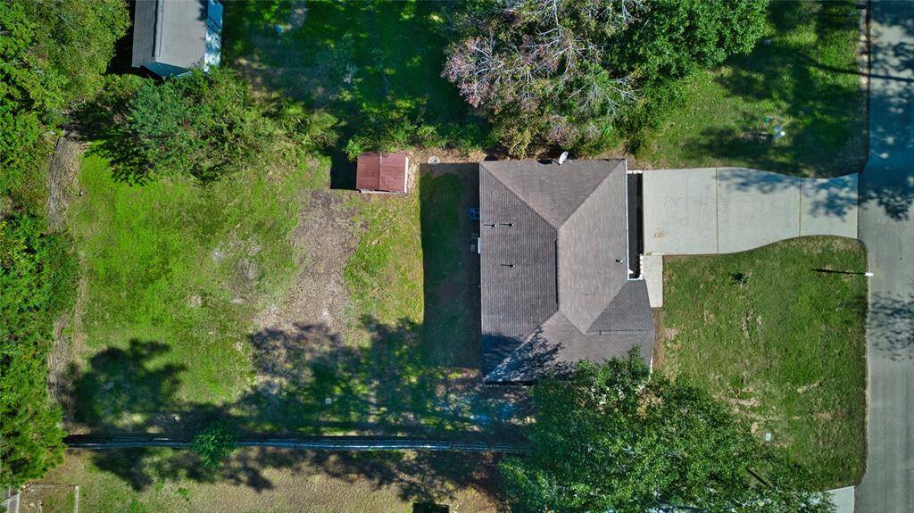 Explore this stunning drone view of a house nestled amidst a lush forest, offering the perfect blend of privacy and natural beauty.
