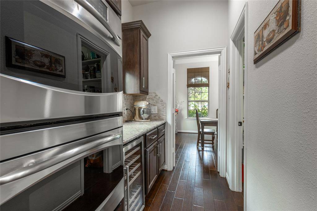 View of butlers pantry. Door to the right is to the walk-in pantry.