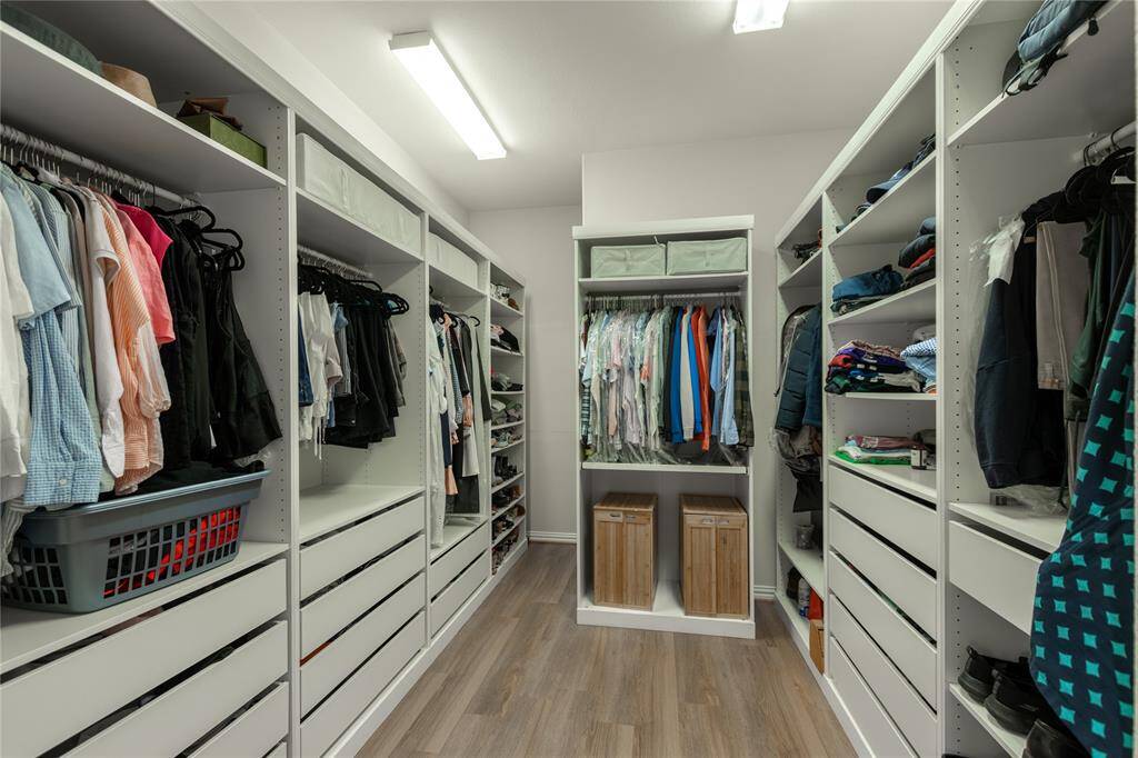 Custom built primary closet.