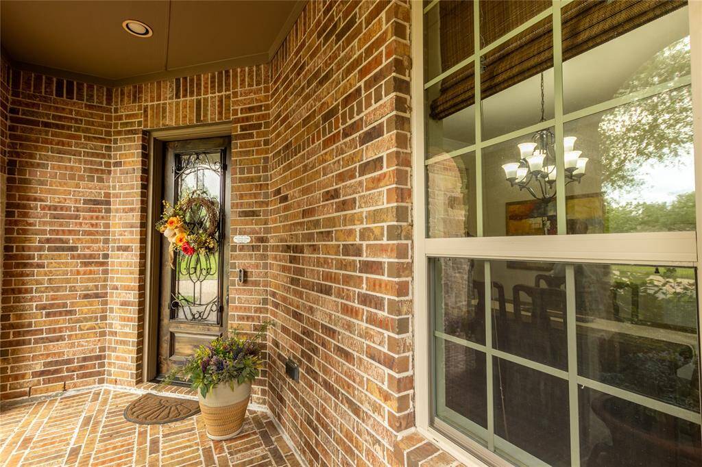Close-up of entry with brick pavers.