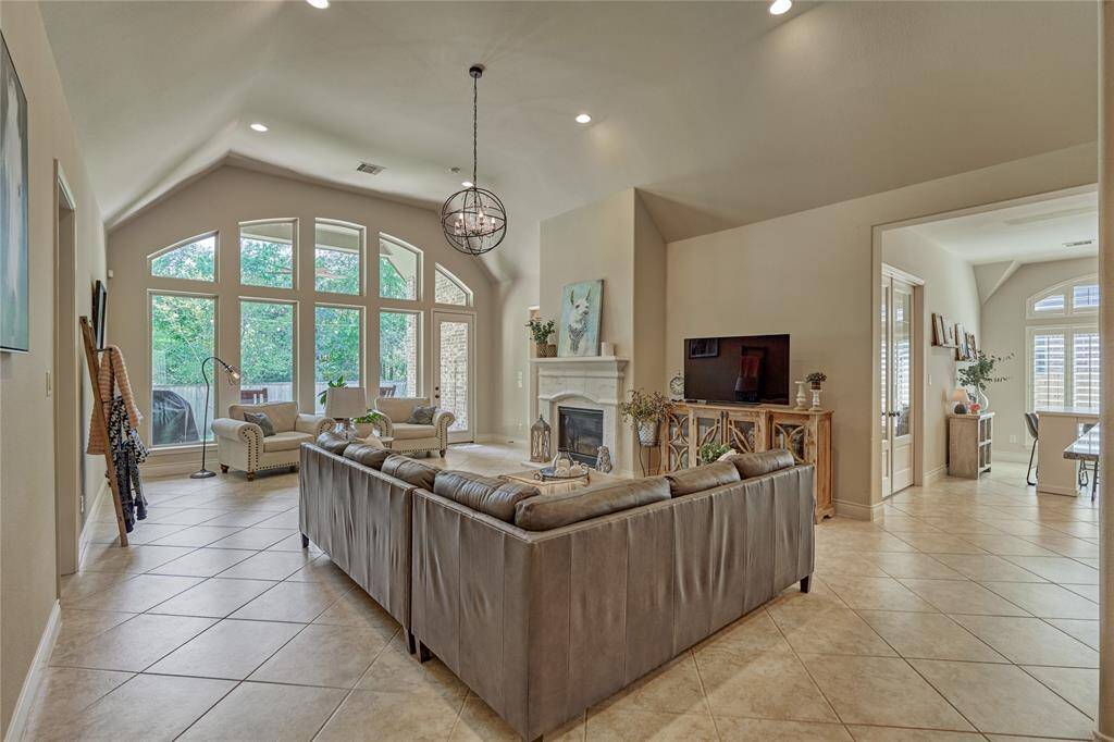 The placement of the cast stone gas log fireplace allows for space to accommodate your TV.