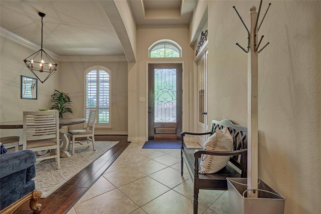 This home has soaring ceilings with crown molding, intricate architectural details, and elegant plantation shutters, among other remarkable details.