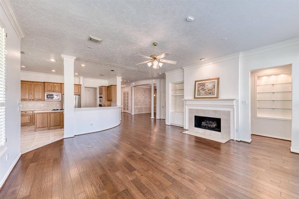 A different view of the well thought out floor plan and the centrally located kitchen.  The doorway to the right of this picture is the entrance to the Primary Suite and the glass shelved art niche, perfect for your collectibles!