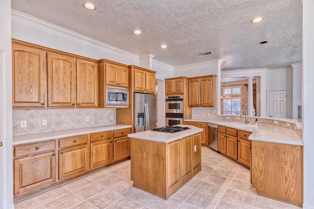Stainless appliances and tons of storage space in this very large kitchen! Note the owner removed the old ceiling light panel and replaced with recessed lighting for a cleaner, more modern look.