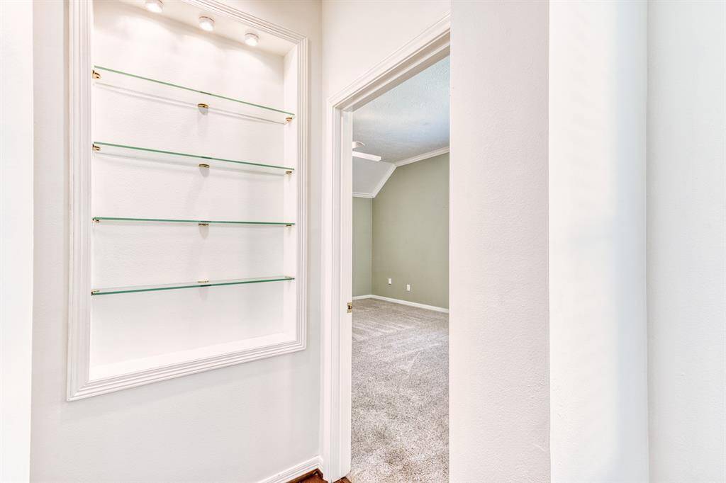 The owner was very creative, adding glass shelves and lighting in the art niche by the Primary Bedroom.