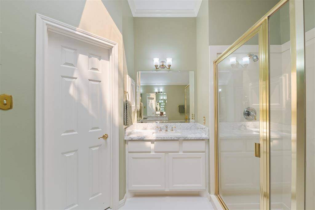 View of the separate vanity and the door to one of the two walk-in closets.