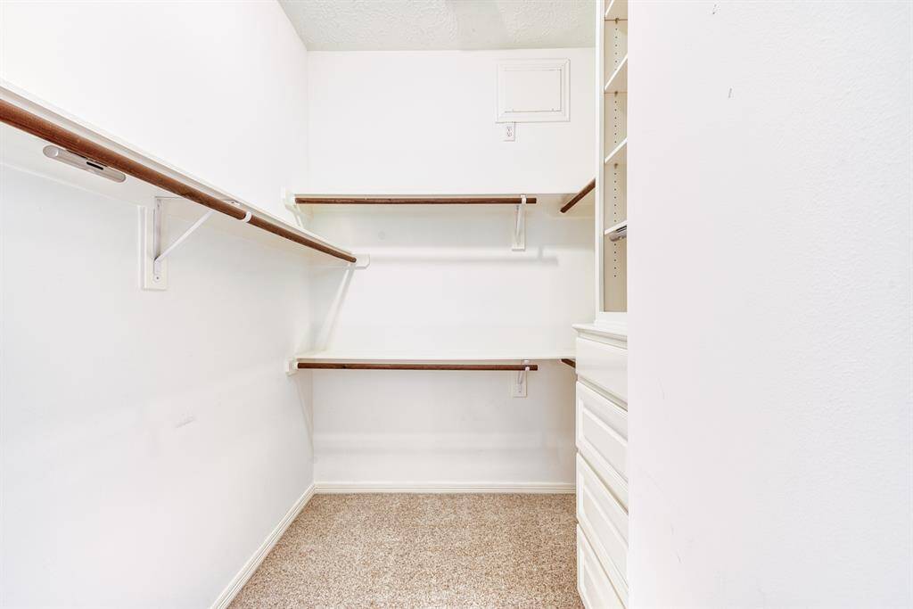 Closet with built in chest and shelves, and a lot of hanging space.