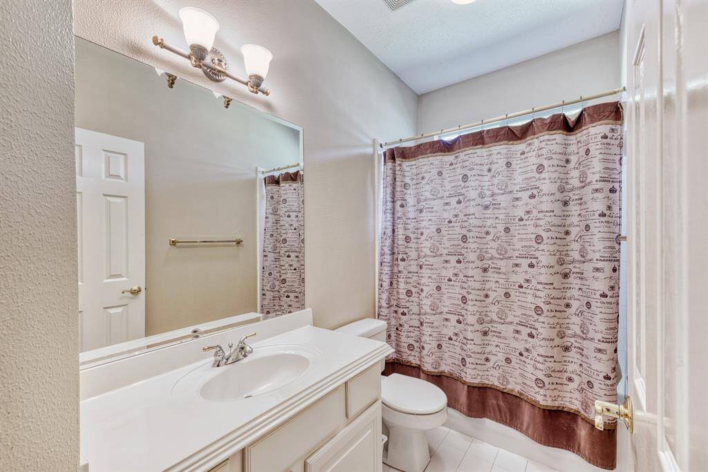 This secondary bathroom is located near both bedrooms.